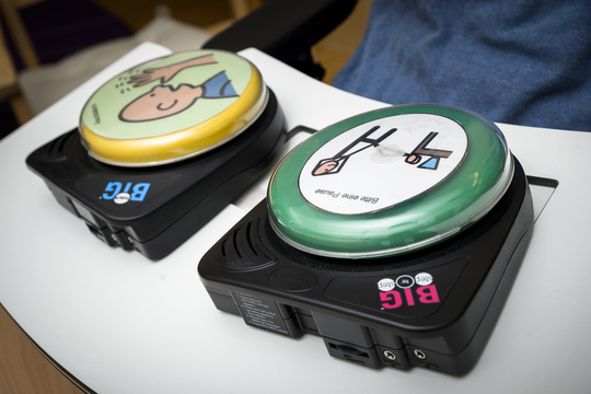 Foto: Zwei Tasten mit Symbolen zur Unterstützten Kommunikation, Fotocredit: Ulrike Rauch